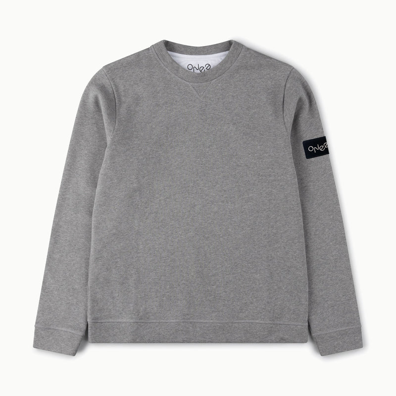 ONE Earth logo embroidered patch sewn onto grey marl organic cotton sweatshirt on left  bicep