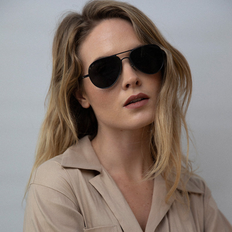 Woman wearing aviator sunglasses with polarised lenses