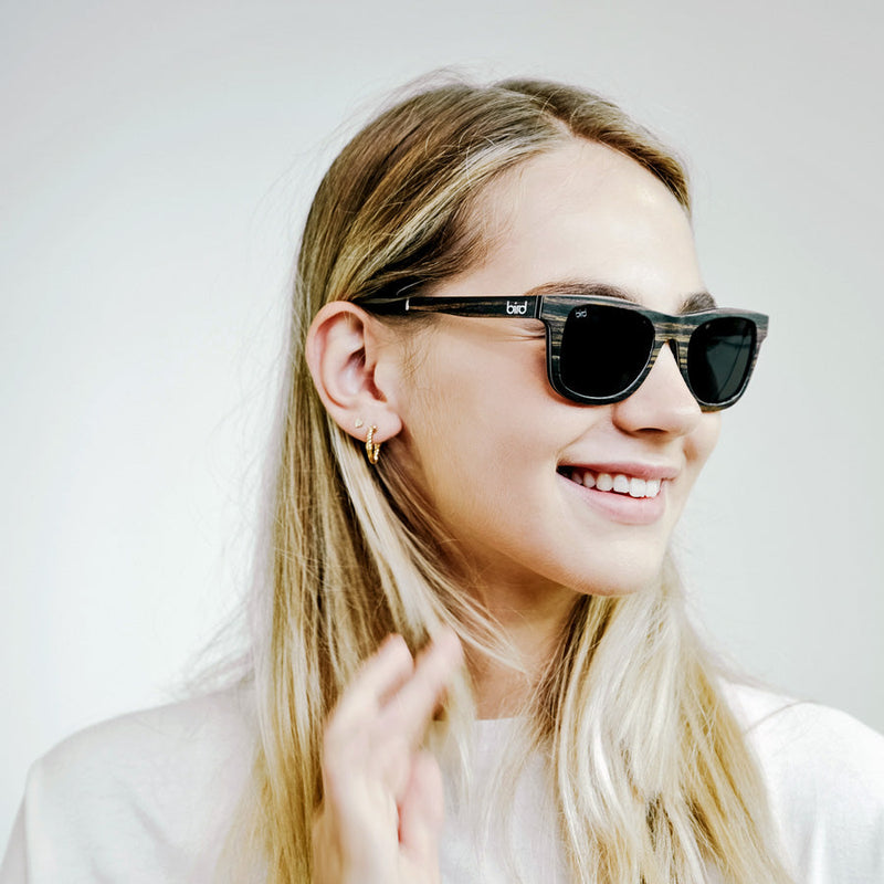 Blonde women wearing Wooden sunglasses with grey polarised lenses