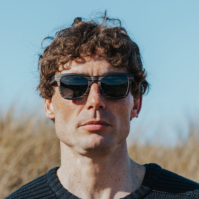 Man wearing Wooden sunglasses with grey polarised lenses