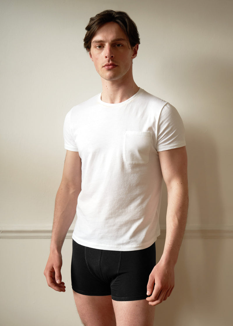Single Pocket White T shirt. Slim fitting. On Male model size small with dark hair. Worn with the black boxers.
