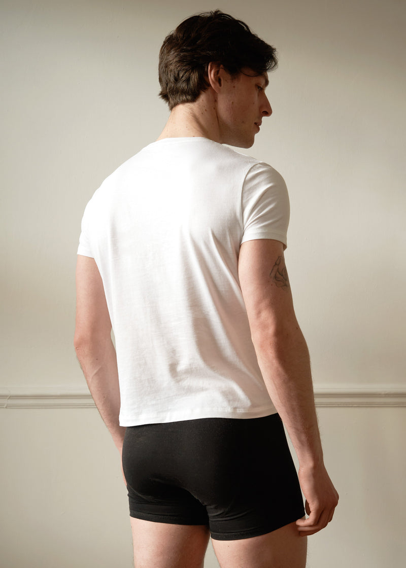 Single Pocket White T shirt. Slim fitting. On Male model size small with dark hair. Worn with the black boxers. back view